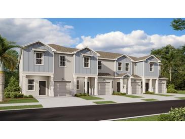 Beautifully designed townhomes feature individual garages and attractive architectural details at 2611 Skyline Loop, Kissimmee, FL 34758