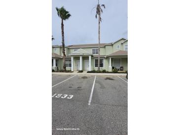 Inviting condo building with landscaped grounds and designated parking at 1533 Still Dr, Clermont, FL 34714