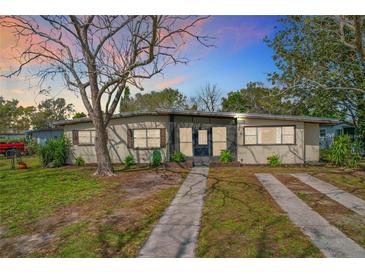 Charming single-story home with a well-maintained lawn and mature landscaping at 1625 Crystal E Ct, Lakeland, FL 33801