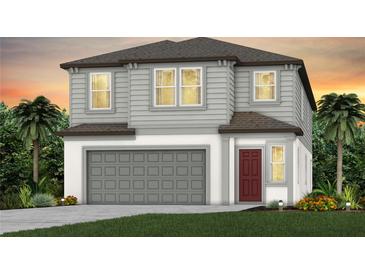 Two-story home with gray siding, a red door, and an attached two-car garage at 284 Woodsage Pl, Lake Alfred, FL 33850