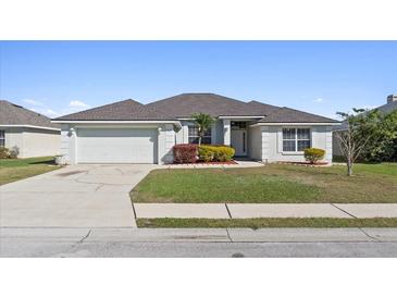 Charming single-story home with a well-manicured lawn and an attached two-car garage at 524 Buckshot Ln, Lakeland, FL 33809