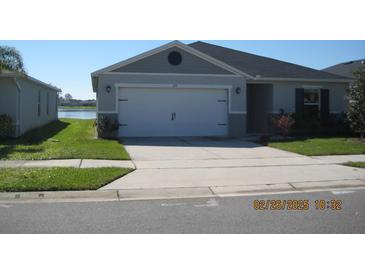 Charming one-story home featuring a two car garage, well-maintained lawn, and traditional design at 1371 Pompay Dr, Davenport, FL 33896