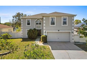 Charming two-story home with a well-maintained lawn and a two-car garage at 913 Parasol Pl, Kissimmee, FL 34759