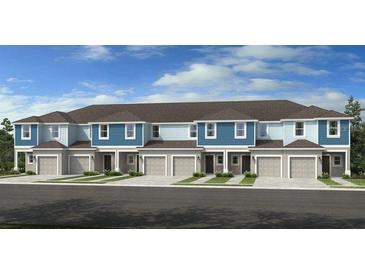 New construction townhomes showcasing a traditional two-story style with attached garages at 161 River Front Way, Edgewater, FL 32141