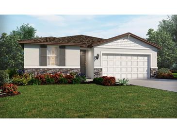 Charming single-story home featuring stone accents and a well-manicured lawn at 2113 Rosewood Dr, Bartow, FL 33830