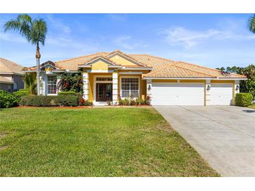 Charming single-story home with tile roof, well-manicured lawn and lush landscaping with a convenient two car garage at 11321 Ledgement Ln, Windermere, FL 34786