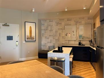Contemporary kitchen boasts a spacious island, modern appliances, and a cozy bench nook at 3151 Sunset Walk Dr # 314, Kissimmee, FL 34747