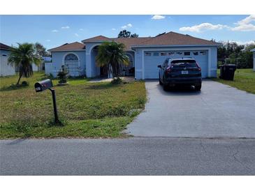 Charming single-story home featuring a two-car garage and drought-resistant landscaping at 661 Crane Dr, Kissimmee, FL 34759