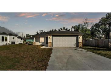 Charming single-story home with a well-maintained lawn and a two-car garage at 420 Tecumseh N Ave, Fort Meade, FL 33841