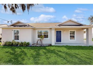 Charming single-story home with a well-manicured lawn and inviting blue front door at 3230 Baird Ave, Lakeland, FL 33805