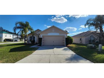 Charming one story home featuring a well-manicured lawn and a two car garage at 1404 Country Chase Dr, Lakeland, FL 33810