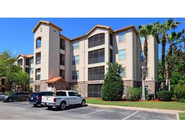 Beautiful stucco condominium with multiple balconies, stone accents, and parking at 8010 Tuscany Way # 5301, Davenport, FL 33896