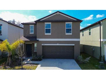 Two-story home showcasing its neutral-toned exterior and attached two-car garage at 2244 Teneroc Trl, Lakeland, FL 33805