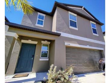 Two-story home featuring a two-car garage, well-maintained landscaping, and a welcoming front entrance at 2244 Teneroc Trl, Lakeland, FL 33805