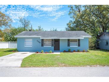 Charming single-story home featuring a well-manicured lawn and a freshly painted exterior at 1126 Waterview E Blvd, Lakeland, FL 33801