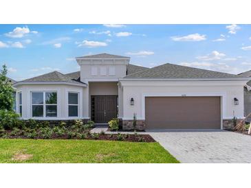 Charming single-story home featuring a well-manicured lawn and a welcoming two-car garage at 5646 Nevis Ter, Kissimmee, FL 34758