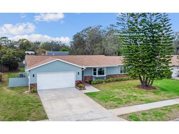 Charming one-story home featuring manicured lawn, attached garage, and brick accents at 226 Selkirk Way, Longwood, FL 32779