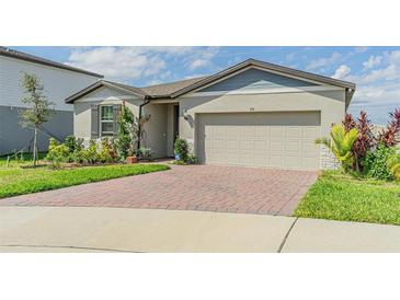 Charming single-story home with manicured landscaping and brick paved driveway at 928 Cambridge Dr, Winter Haven, FL 33881