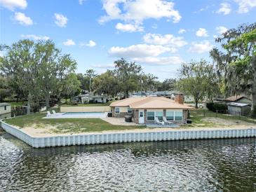 Waterfront home featuring a private pool with beautiful waterway views at 830 County Rd 457, Lake Panasoffkee, FL 33538
