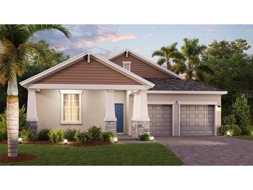 Charming single-story home featuring a stone-accented facade, two-car garage, and a beautifully landscaped front yard at 1906 Clear Sky Dr, Kissimmee, FL 34744