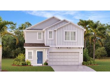 Charming two-story home featuring a light gray exterior, a blue door and a well-manicured lawn at 5618 Gingham Dr, Kissimmee, FL 34758