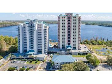 Stunning high-rise condo building with lake views and manicured landscaping offers resort-style living at 13415 Blue Heron Beach Dr # 1201, Orlando, FL 32821