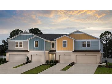 Charming townhomes boast colorful exteriors, private driveways, and attached garages at 3831 King Hill Dr, Haines City, FL 33844
