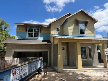 Two-story home under construction features a welcoming front porch and large windows at 3611 Chelsea St, Orlando, FL 32803