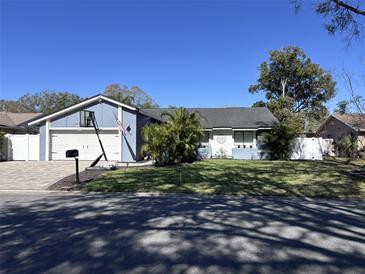 Charming single-Gathering home with a well-maintained front yard and a basketball hoop above the garage at 105 Ingram Cir, Longwood, FL 32779