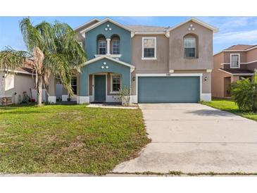 Two-story home featuring blue-gray exterior paint, well-manicured lawn and a two-car garage at 3189 Kearns Rd, Mulberry, FL 33860