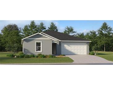 Charming single-story home with gray stucco, a two-car garage, and green lawn at 1185 Hour Glass Rd, Lakeland, FL 33801