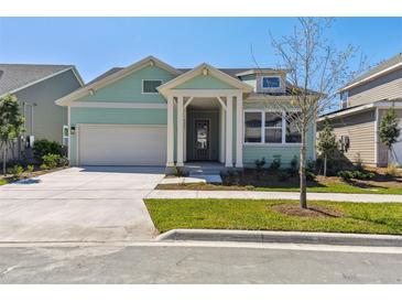 Charming single-Gathering home featuring a two car garage, manicured lawn, and a welcoming front porch at 6221 Trailblaze Bnd, St Cloud, FL 34771