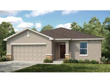 Charming single-story home with a two-car garage and well-maintained landscaping at 7396 Capstone Dr, Groveland, FL 34736