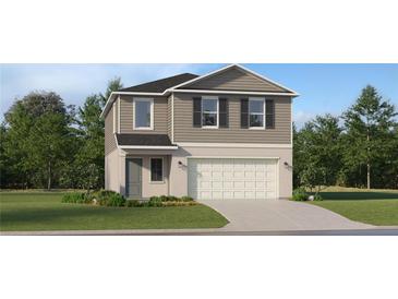 Charming two-story home with gray siding, lush landscaping, and a two-car garage at 958 Hour Glass Rd, Lakeland, FL 33801