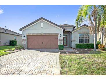 Charming single-story home with a paver driveway, two-car garage, and well-maintained landscaping at 474 Del Sol Ave, Davenport, FL 33837