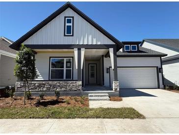 Charming two-story home featuring stone accents, modern architectural details and an attached two car garage at 6615 Quest St, St Cloud, FL 34771