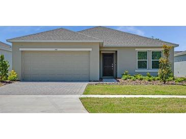 Charming single-story home featuring an attached two-car garage and well-maintained lawn at 140 Jones Fish Camp Rd, Edgewater, FL 32141