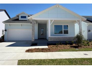 Charming single-story home featuring a light blue exterior, a covered front porch, and an attached two-car garage at 3105 Expedition Dr, St Cloud, FL 34771