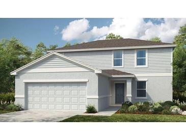 Charming two-story home with a two-car garage, and a neatly landscaped front yard at 1920 Rosewood Cir, Lakeland, FL 33810