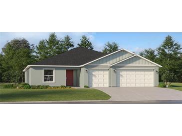 Charming single-story home with a two-car garage, featuring a modern facade and well-maintained lawn at 1261 Deepwater Cir, Eagle Lake, FL 33839