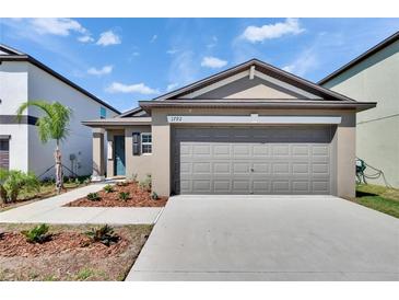 Charming single Gathering home with a well-manicured lawn and two car garage at 1792 Yellow Trl, Lakeland, FL 33801