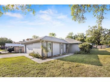 Charming single-story home with lush green lawn, mature trees, and cozy curb appeal at 3247 S Polk Ave, Lakeland, FL 33803