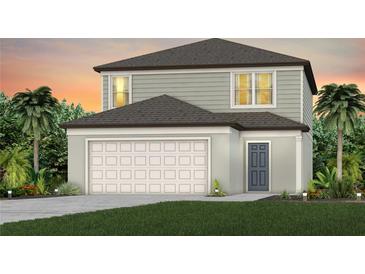 Charming two-story home with a grey and white facade, attached garage, and lush landscaping at 1431 Hamilton Way, Lake Alfred, FL 33850
