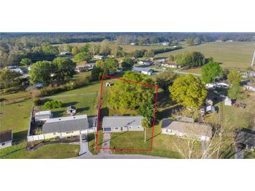 Aerial view of a charming single Gathering home with a mature lawn and property boundaries at 5728 Ne 21St Avenue Rd, Ocala, FL 34479