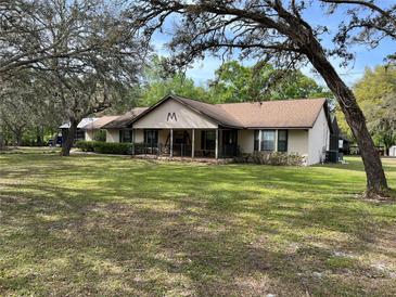 Single Gathering home on a large lawn with mature trees and stone accents at 4586 Cr 696, Webster, FL 33597