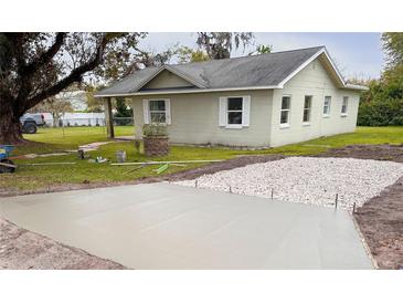 Charming single-story home with a new driveway and well-maintained lawn at 203 Glenwood Dr, Lakeland, FL 33805