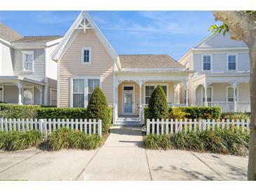 Charming home with a white picket fence and a welcoming front porch, offering curb appeal and a sense of community at 1002 Periwinkle Ct, Celebration, FL 34747