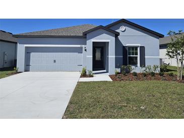 Charming single-story home featuring a two-car garage, neatly landscaped front yard, and modern architectural details at 1641 Nantucket Way, Winter Haven, FL 33884