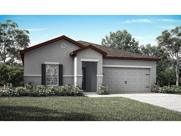 Charming single-story home with a two-car garage, gray stucco exterior, and well-manicured landscaping at 1798 White Elephant Loop, Winter Haven, FL 33884