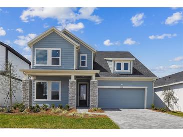 Charming two-story home featuring a two-car garage, stone accents, and beautifully landscaped front yard at 5932 Bristle Oak St, Mount Dora, FL 32757